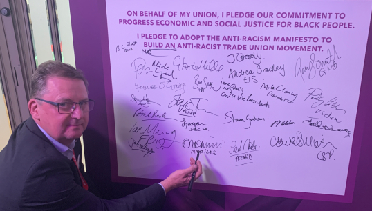 Image:Nautilus general secretary Mark Dickinson signs the TUC anti-racism charter. Image: Nautilus International