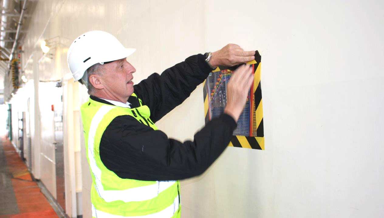A Wightlink ferry crew member fixes a poster of appreciation for crew and other essential workers created by school children in April onboard the flagship Victoria of Wight. Image: Wightlink Image:A Wightlink ferry crew member fixes a poster of appreciation for crew and other essential workers created by school children in April onboard the flagship Victoria of Wight. Image: Wightlink
