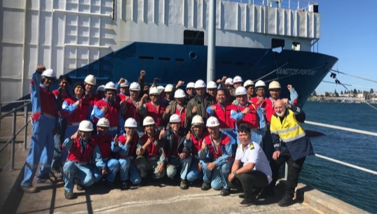 The crew of the Fortune pictured with ITF volunteer Graham 'Yappy' Archer (right) during one of many visits that took place in their five months-long abandonment. Image: ITF Image:The crew of the Fortune pictured with ITF volunteer Graham 'Yappy' Archer (right) during one of many visits that took place in their five months-long abandonment. Image: ITF