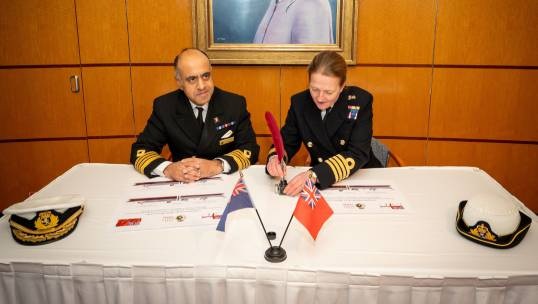Queen Mary 2 master Captain Aseem Hashmi MNM signs the affiliation agreement with HMS Queen Elizabeth's commanding officer Captain Claire Thomson OBE RN. Image: Courtesy of Capt Hashmi Image:Queen Mary 2 master Captain Aseem Hashmi MNM signs the affiliation agreement with HMS Queen Elizabeth's commanding officer Captain Claire Thomson OBE RN. Image: Courtesy of Capt Hashmi