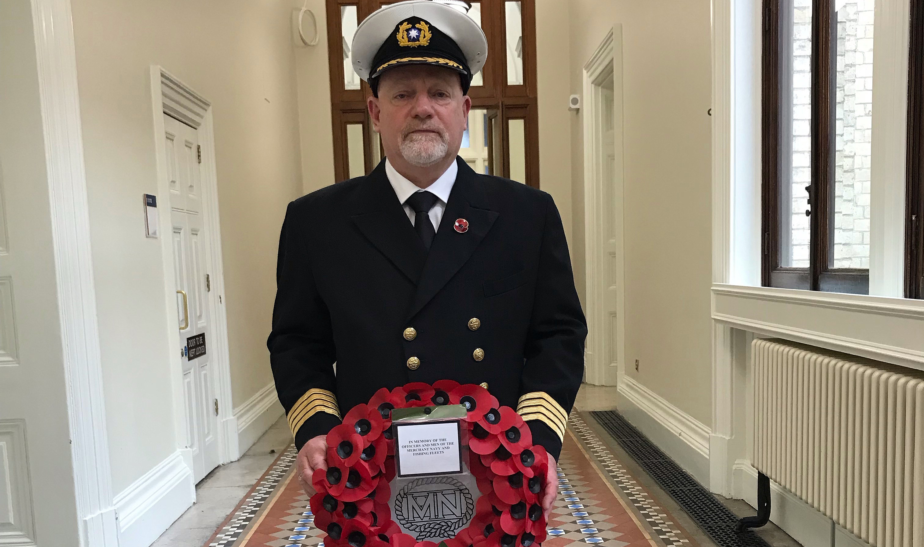 Nautilus member Captain David Johnstone with the Cenotaph wreath. Image:Nautilus member Captain David Johnstone with the Cenotaph wreath.