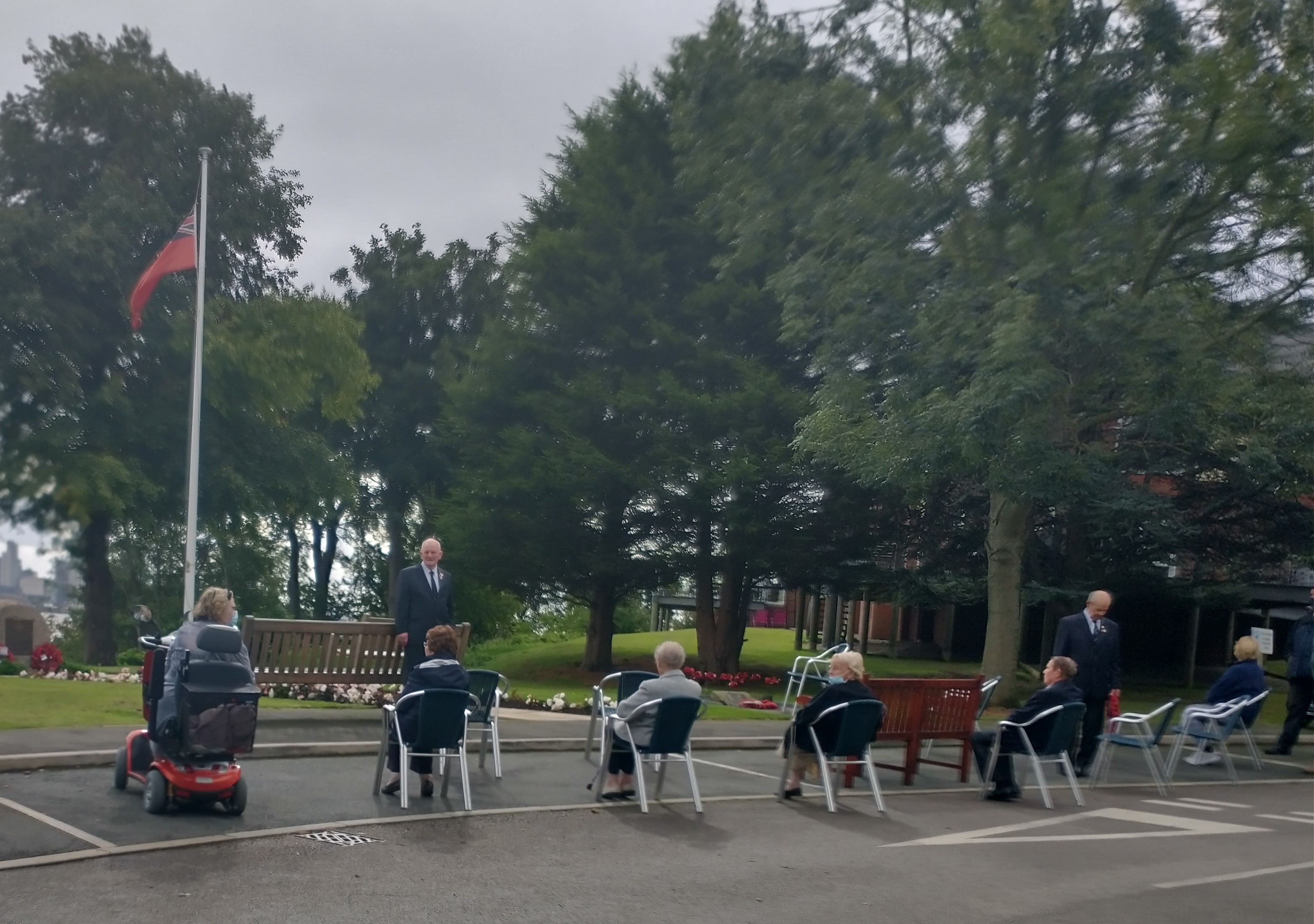 Image:Residents of Mariners' Park gather to for a socially distanced ceremony to commemorate Merchant Navy Day. Image: Nautilus International.